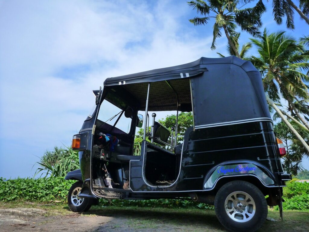 black tuktuk in clear view